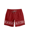 The front of red swim trunks with a strip of knitted pattern design featuring white snowflakes and geometric shapes across the bottom of the legs. The Stōk logo is displayed in white on the left leg strip of pattern, maintaining a clean and simple contrast against the intricate design. There is a white shoelace like tie closure on the front of the waistband.