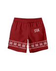 The front of red swim trunks with a strip of knitted pattern design featuring white snowflakes and geometric shapes across the bottom of the legs. The Stōk logo is displayed in white on the pocket on the right leg.