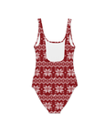 The back of a red one piece swimsuit with a knitted pattern design featuring white snowflakes and geometric shapes throughout.